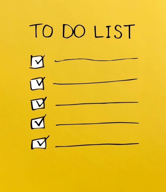 To do list with woman using a laptop